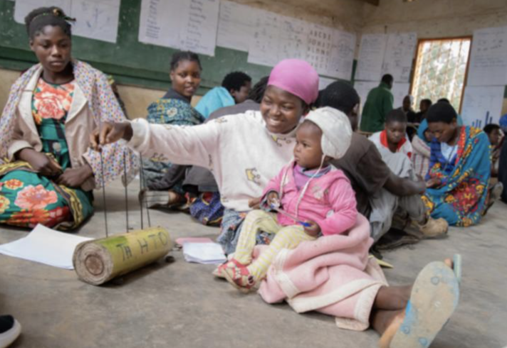 Learner with baby in a community-based accelerated learning centre, Malawi