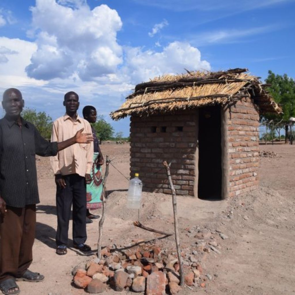 Malawi Senior Chief Kalu showing how improved toilets improves health of his people
